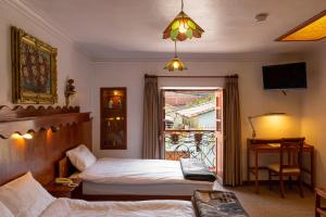 Postel nebo postele na pokoji v ubytování Hotel La Posada de Atahualpa