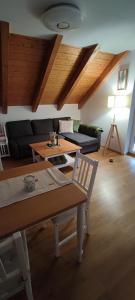 a living room with a couch and a table at FeWo am Park- mit Ausblick auf den Europa-Park in Rust