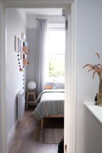 a bedroom with a bed and a window at Penthouse Seaview Warrior Square in Hollington