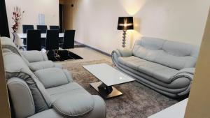 a living room with a couch and chairs and a table at CJ Suites - Executive 3Br and Dsq in Eldoret in Eldoret