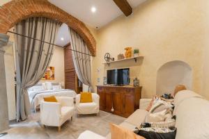 een woonkamer met een bed en een televisie bij Little Patio in Florence