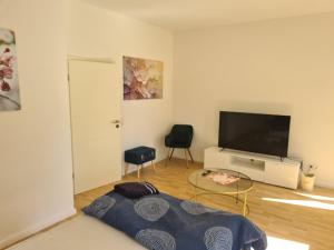 a living room with a large flat screen tv at Chemnitz - Home Sweet Home in Chemnitz