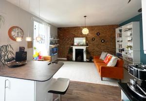 a living room with a couch and a fireplace at Penthouse Seaview Warrior Square in Hollington