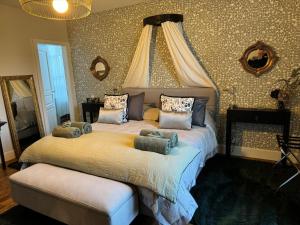 a bedroom with a large bed with pillows on it at Villa Eulalie B&B Guest House- Champagne Edouard Duval nestled in the Champagne area in Bligny
