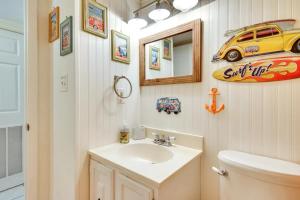 a bathroom with a sink and a car on the wall at Captain's Quarters in Ocean City +36 photos