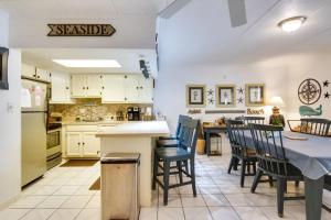 a kitchen and dining room with a table and chairs at Captain's Quarters in Ocean City