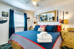 a bedroom with a blue bed and a mirror at Captain's Quarters in Ocean City