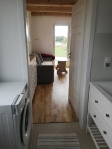 a laundry room with a washer and dryer at Dom nad jeziorem z prywatnym pomostem i linią brzegową in Orzysz