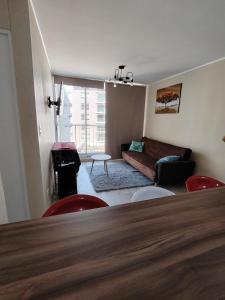 a living room with a couch and a table and chairs at Apartamento de estreno in Arequipa