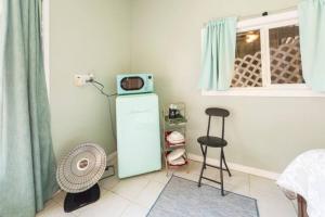 a room with a microwave on top of a refrigerator at Pool Room - Entire Guest Suite - Private Entrance in San Diego