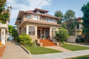 a brown house with a porch and stairs at Pool Room - Entire Guest Suite - Private Entrance in San Diego