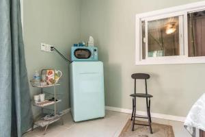 a room with a refrigerator with a microwave on top of it at Pool Room - Entire Guest Suite - Private Entrance in San Diego