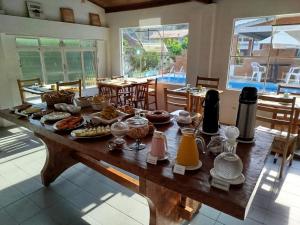 a table with a bunch of food on it at Caminito in Santo Antônio do Pinhal