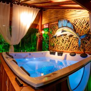 a bathroom with a bath tub with a shark on the wall at Pousada do Bispo in Cabo Frio