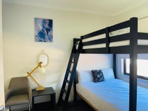 a bedroom with a bunk bed and a chair at D110 Sweet Melon super stay-fantastic in Braybrook