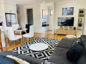 a living room with a couch and a dining room at D110 Sweet Melon super stay-fantastic in Braybrook