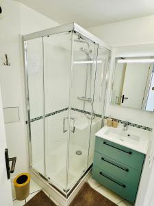a bathroom with a glass shower and a sink at La Méditerranée comme vous l'aviez rêvée in Saint-Raphaël
