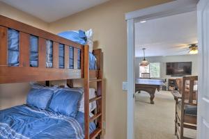 ein Schlafzimmer mit zwei Etagenbetten und einem Schreibtisch in der Unterkunft Lake Loon Hillside Cottage with Private Deck! in Loon Lake