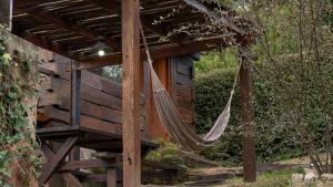 a hammock hanging from a wooden pergola at Willert Cabañas Cumbrecita in La Cumbrecita