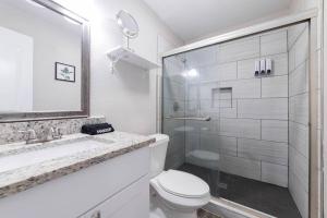 a white bathroom with a toilet and a shower at Walk to ATT-Glblife-Free Parking-Min to attraction in Arlington +24 photos
