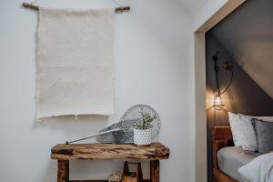 a bedroom with a bed and a table with a plant at Sailor's Catch in Hokitika