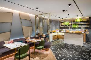 a restaurant with two tables and a counter at Occidental Alicante in Alicante +37 photos