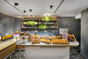 a bakery with a variety of pastries on a counter at Occidental Alicante in Alicante