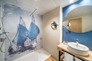 a bathroom with a sink and a shower at Occidental Alicante in Alicante