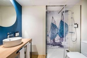 a bathroom with a sink and a shower at Occidental Alicante in Alicante