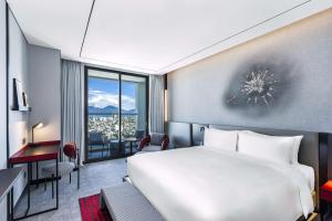 A bed or beds in a room at Radisson RED Danang