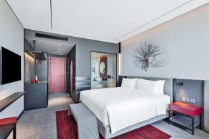A bed or beds in a room at Radisson RED Danang
