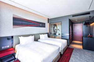 A bed or beds in a room at Radisson RED Danang