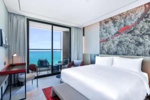 A bed or beds in a room at Radisson RED Danang