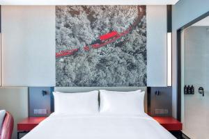 A bed or beds in a room at Radisson RED Danang