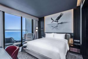 A bed or beds in a room at Radisson RED Danang