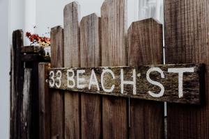 a sign on a wooden fence with the wordasted at Sailor's Catch in Hokitika