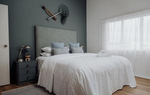 a bedroom with a bed with a baseball bat on the wall at Sailor's Catch in Hokitika