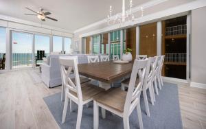 a dining room with a table and chairs at Phoenix Gulf Towers 405 condo in Gulf Shores