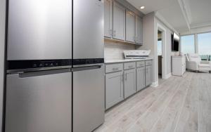 a kitchen with white cabinets and stainless steel appliances at Phoenix Gulf Towers 405 condo in Gulf Shores