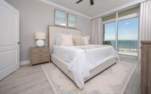 a bedroom with a bed with a view of the ocean at Phoenix Gulf Towers 405 condo in Gulf Shores +75 photos