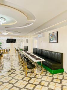 a waiting room with a long table and chairs at Les HOTELS TALHAYA, NOUAKCHOTT in Nouakchott