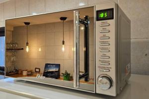 a microwave oven with a clock on top of a counter at Ush in Ushuaia