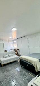 a living room with two beds and a couch at Apartamento Asa Norte com Varanda in Brasilia