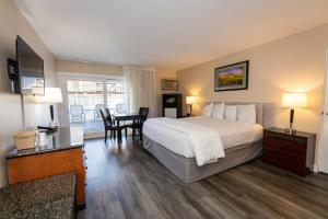 a hotel room with a bed and a table and chairs at Pea Soup Andersen's Inn in Buellton +58 photos