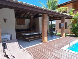 un patio con camino e terrazza in legno di Apartamento tranquilo elegante espaçoso a Porto Seguro