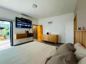 a bedroom with a bed and a flat screen tv at Departamento en MossoCafe Oaxaca in Oaxaca City +6 photos