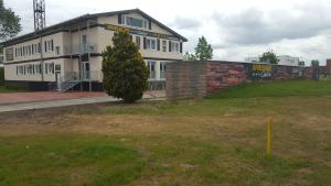 a large white building with a tree in front of it at CASILINO Hotel A 24 Wittenburg in Wittenburg