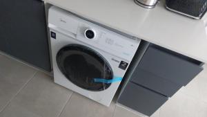 a washing machine sitting under a counter in a kitchen at Sunrise in La Serena