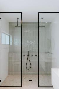 a bathroom with a shower with glass doors at Mudgee Haven - Stunning Terra Modern Design in Mudgee