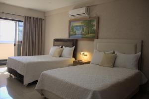 Ένα ή περισσότερα κρεβάτια σε δωμάτιο στο Darling Hotel Ciudad del Este